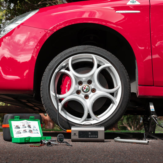 Car broken down on side of the road with a portable jump starter