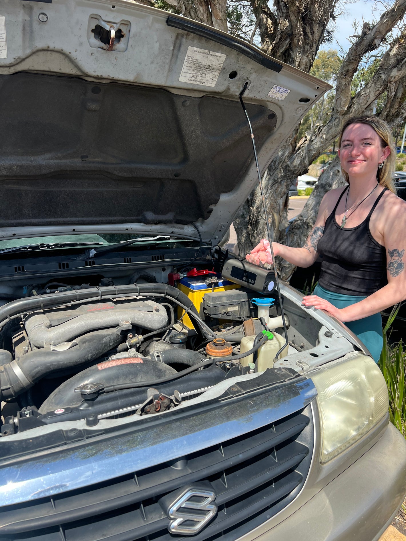 picture of another happy girl using a portable jump starter and tyre inflator