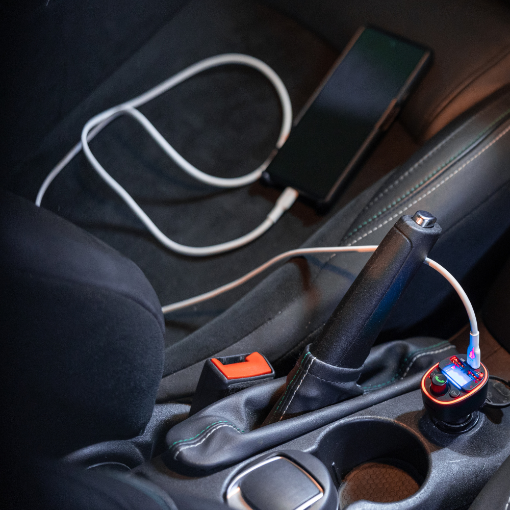 USB car charger with cable attached inside a center console