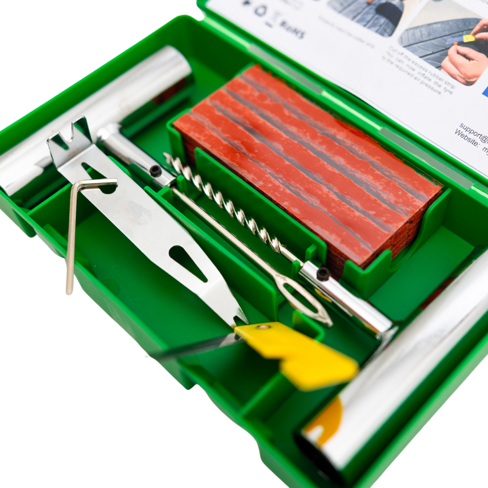 Open Tyre Repair Kit by My Garage Hero showing stainless steel T-handle tools, spiral probe, insertion tool, rubber repair plugs, and printed puncture repair instructions inside a green hard case.