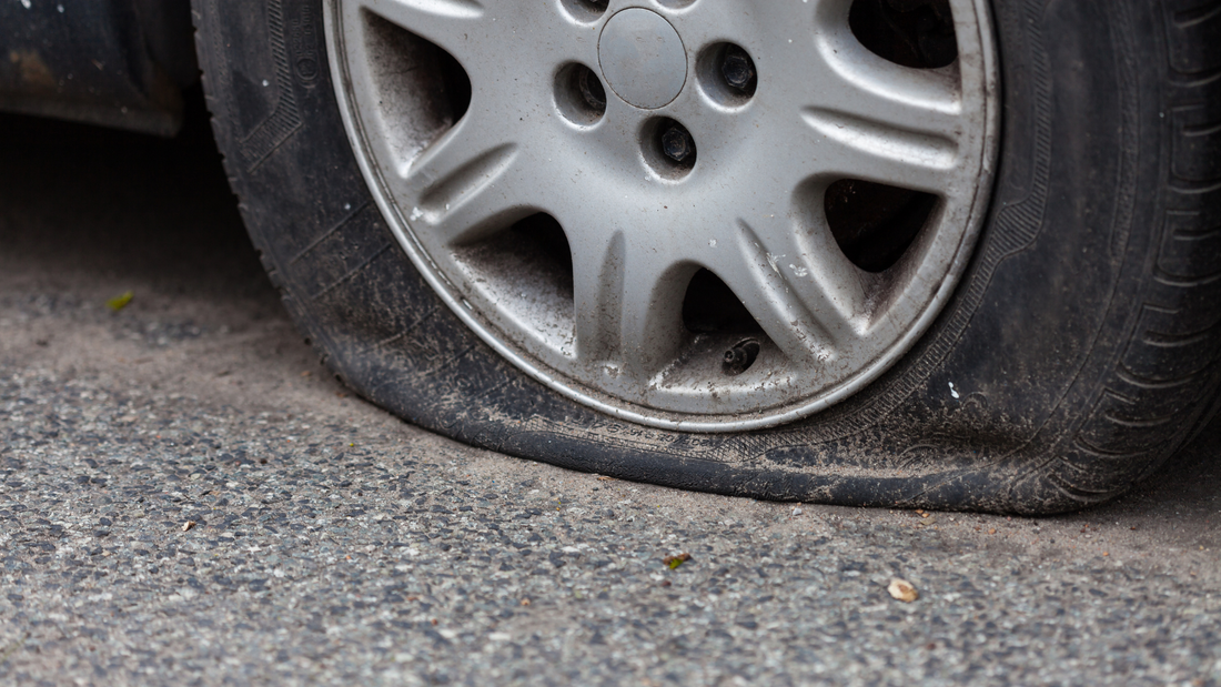 flat tyre on the side of the road 