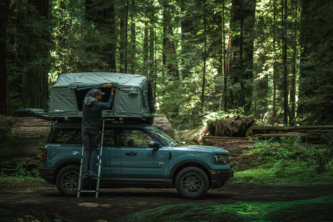 4×4 vehicle fitted with a roof top tent parked by a scenic lakeside during sunset highlighting Australian outdoor camping