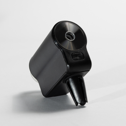 Car Diffuser – Premium Fragrance shown in a close-up white studio shot, highlighting the brushed metal top, fragrance outlet, and clip-on mount for attaching to a car vent.