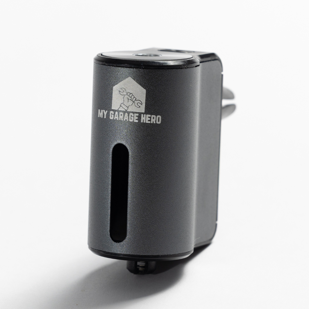 Car Diffuser – Premium Fragrance shown in a white studio setup, featuring the front logo, fragrance slot, and compact cylindrical design with a clean, minimal aesthetic.