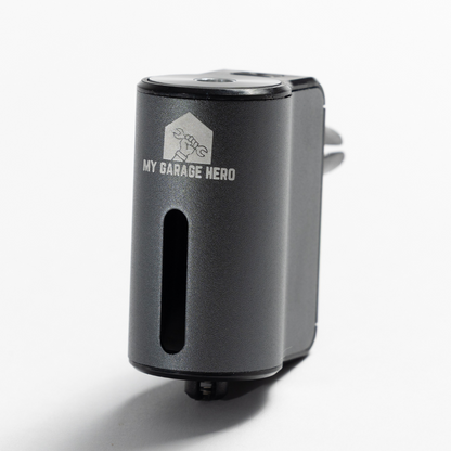 Car Diffuser – Premium Fragrance shown in a white studio setup, featuring the front logo, fragrance slot, and compact cylindrical design with a clean, minimal aesthetic.