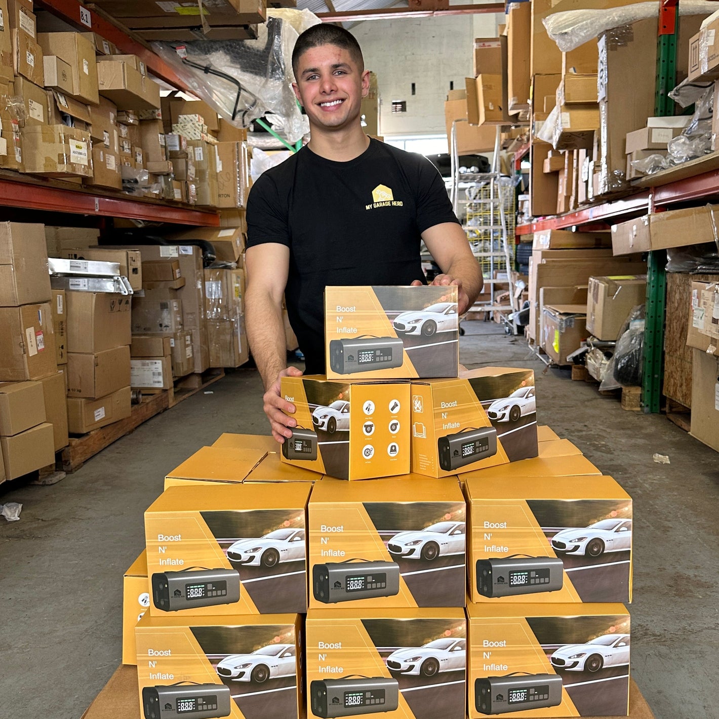 Man standing behind a stack of boxes in a warehouse setting