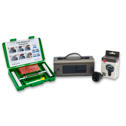 Standard Roadside Rescue Kit displayed in a white studio setup, including the green Tyre Repair Kit case, the Boost N’ Inflate jump starter and tyre inflator, and the Bluetooth car charger in packaging, shown together as a complete emergency bundle.