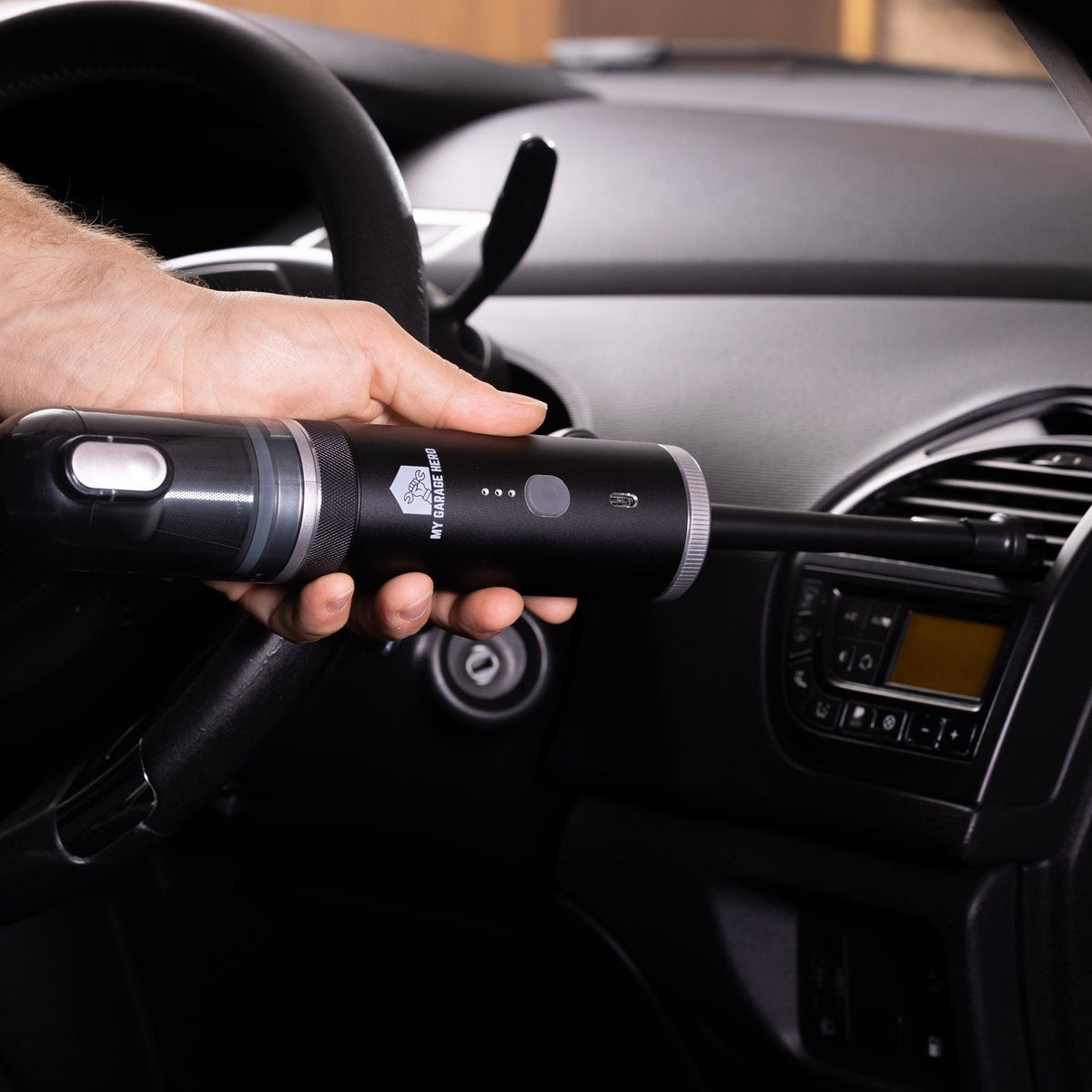 Vacuuming dust from a car dashboard and air vents with the Clean N' Go handheld vacuum